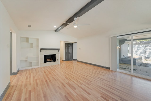 unfurnished living room with lofted ceiling with beams, ceiling fan, and light hardwood / wood-style floors