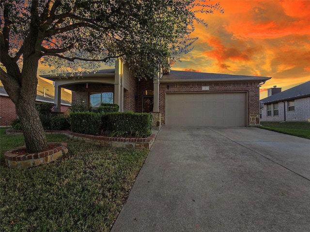 view of front of property featuring a garage and a yard