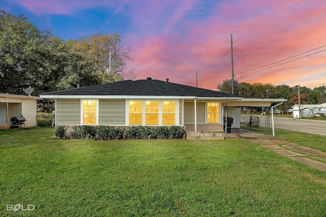 view of front facade featuring a yard and a carport