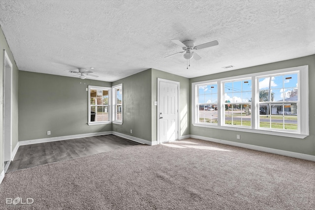 interior space featuring ceiling fan, carpet floors, and multiple windows