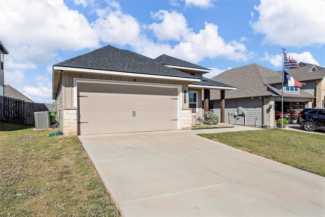 view of front of property with central AC, a garage, and a front lawn