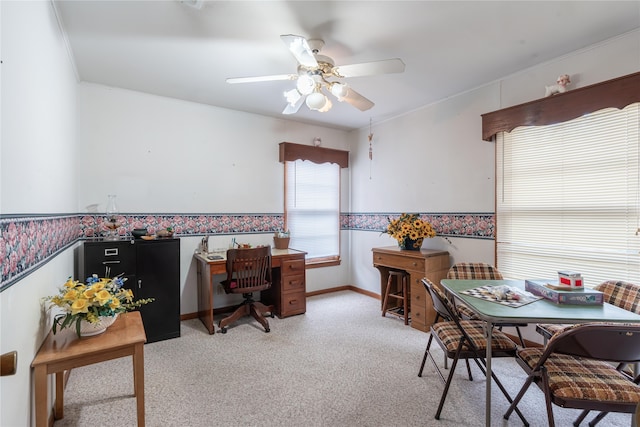 carpeted dining area featuring ceiling fan and ornamental molding