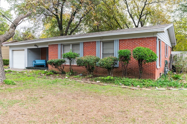 ranch-style house with a garage and a front yard