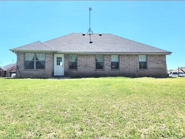 back of house with a lawn