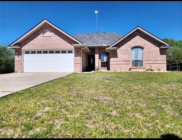1001 Turkey Creek Ct, Bridgeport, TX 76426 - ranch-style home with an attached garage, driveway, brick siding, and a front lawn
