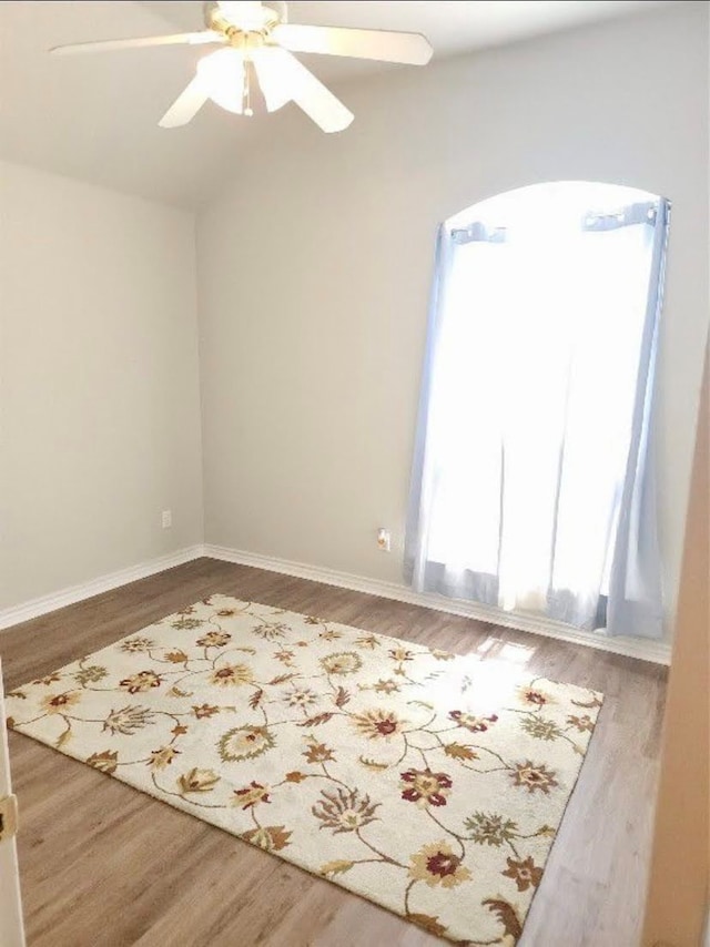 unfurnished room with ceiling fan and wood-type flooring