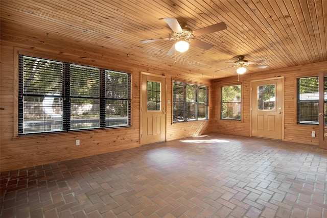 unfurnished sunroom with ceiling fan and wood ceiling