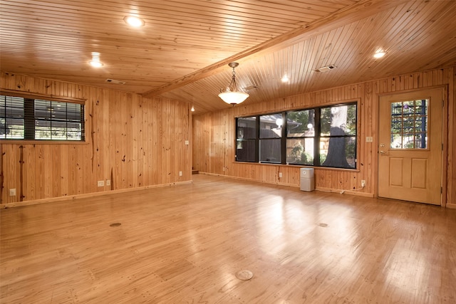 empty room with wood ceiling, a wealth of natural light, and wood-type flooring