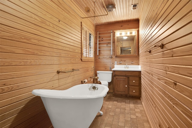 bathroom featuring wood ceiling, vanity, toilet, a tub, and wood walls