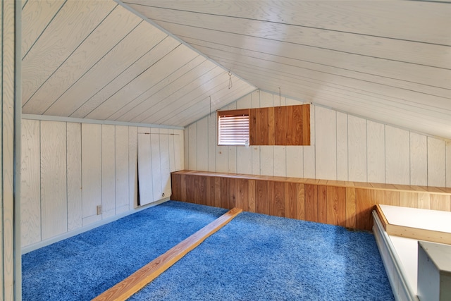 additional living space featuring carpet flooring, vaulted ceiling, wooden walls, and wood ceiling