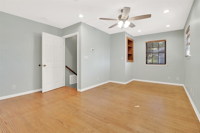 empty room featuring ceiling fan and light hardwood / wood-style floors