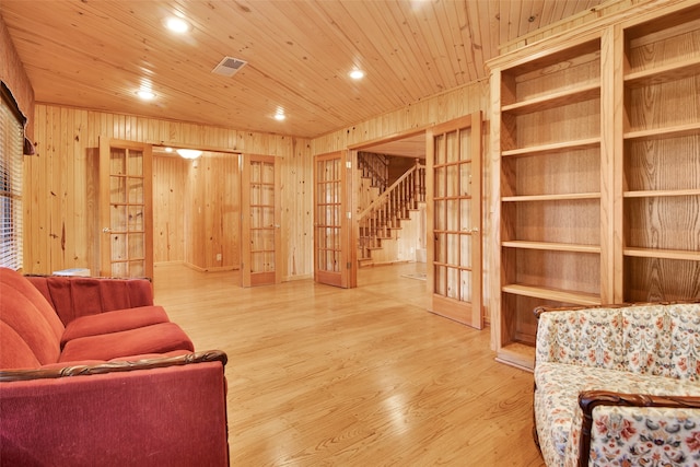 living room with wooden ceiling, french doors, hardwood / wood-style flooring, and wooden walls