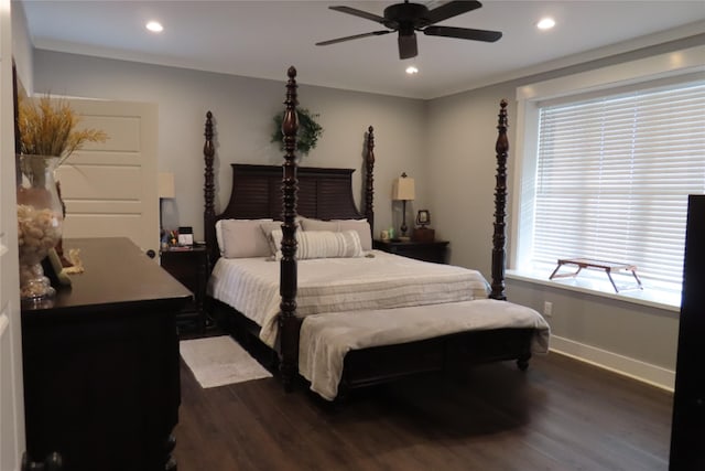 bedroom featuring ceiling fan, crown molding, and dark wood-type flooring