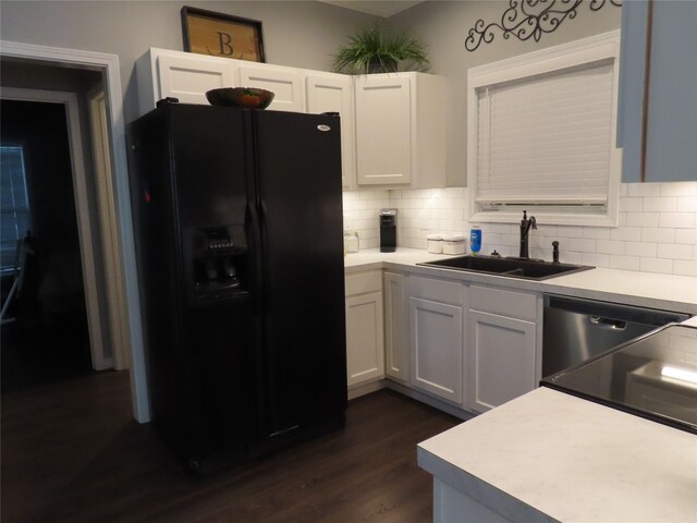 kitchen featuring white cabinetry, sink, dark hardwood / wood-style floors, backsplash, and black appliances