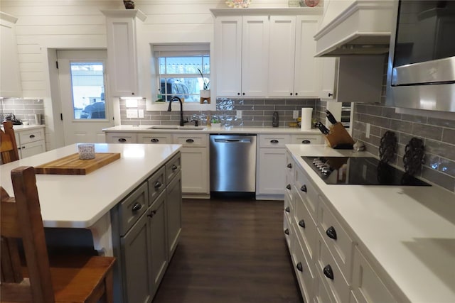 kitchen featuring white cabinetry, dishwasher, sink, and custom range hood