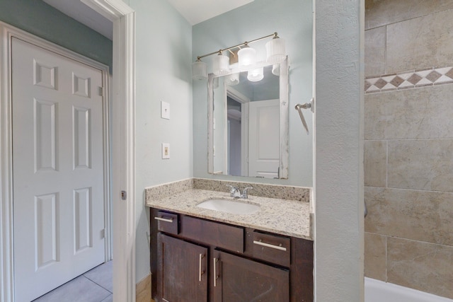 bathroom featuring vanity, a tub to relax in, and tile patterned floors