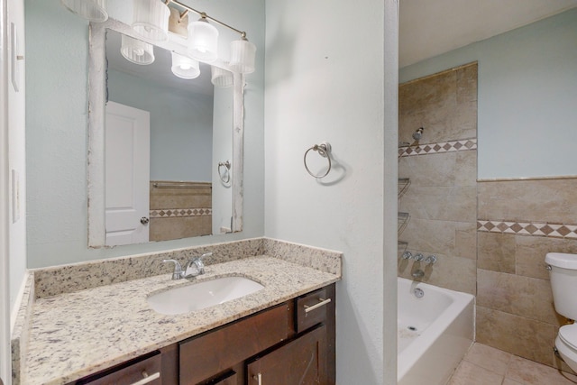 full bathroom with tiled shower / bath combo, tile patterned floors, toilet, vanity, and tile walls