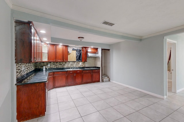 kitchen featuring light tile patterned floors, tasteful backsplash, crown molding, and sink