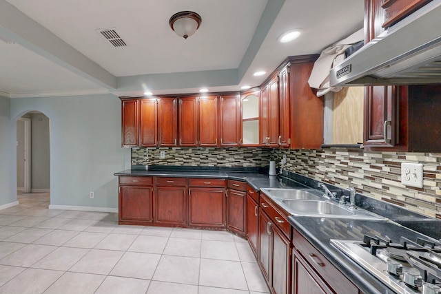 kitchen with decorative backsplash, ornamental molding, sink, stainless steel gas stovetop, and light tile patterned flooring