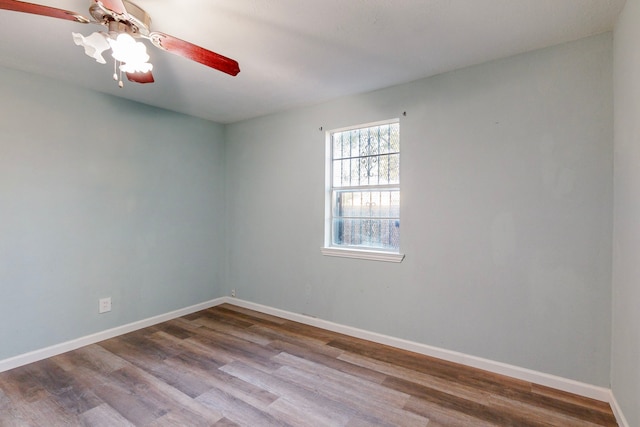 spare room with ceiling fan and wood-type flooring