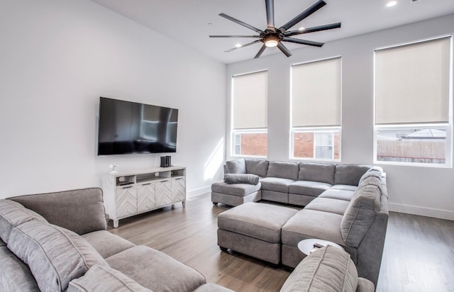 living room featuring hardwood / wood-style floors and ceiling fan