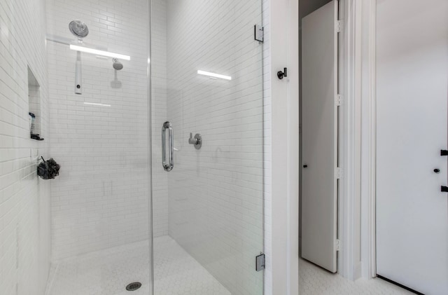 bathroom featuring a shower with door