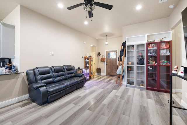 living room with light hardwood / wood-style floors and ceiling fan