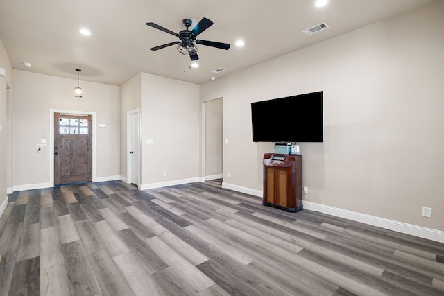 unfurnished living room featuring ceiling fan and hardwood / wood-style floors