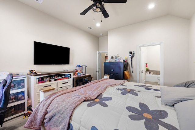 bedroom featuring ceiling fan, light wood-type flooring, connected bathroom, and vaulted ceiling