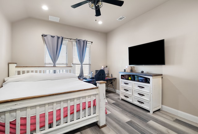 bedroom featuring ceiling fan, lofted ceiling, and light wood-type flooring