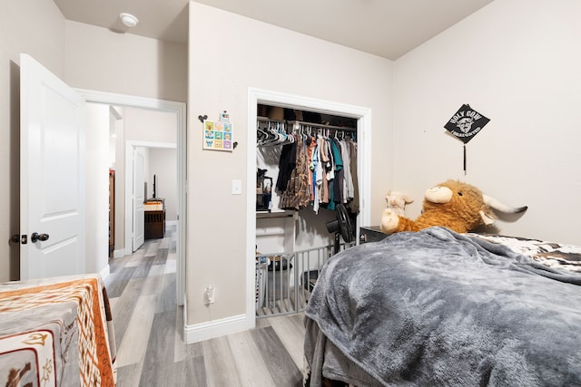 bedroom featuring light hardwood / wood-style floors and a closet