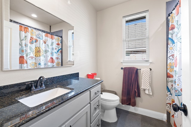 bathroom with tile patterned floors, vanity, toilet, and plenty of natural light