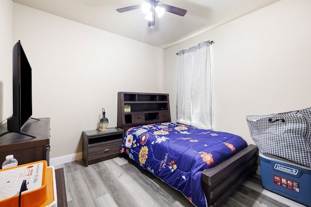 bedroom with ceiling fan and light hardwood / wood-style floors