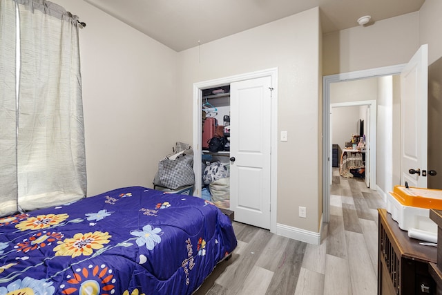 bedroom with a closet and hardwood / wood-style flooring