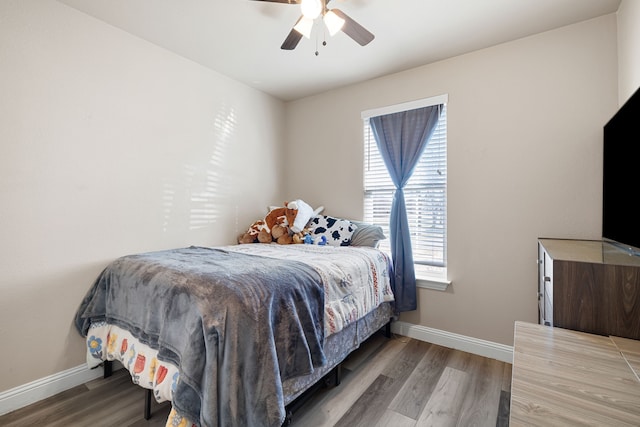 bedroom featuring hardwood / wood-style flooring and ceiling fan