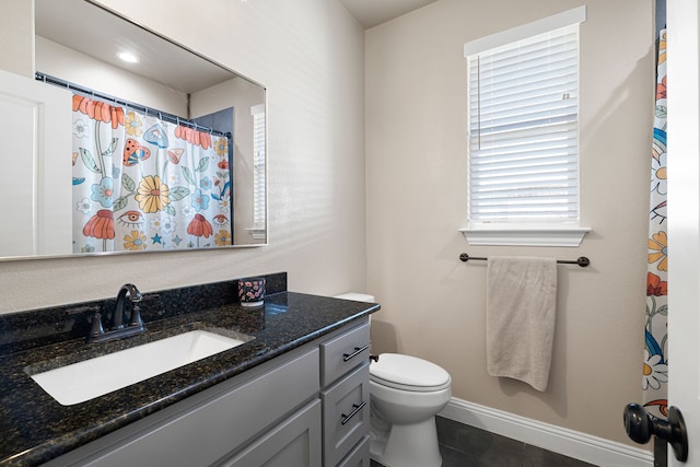 bathroom featuring tile patterned flooring, vanity, a shower with curtain, and toilet