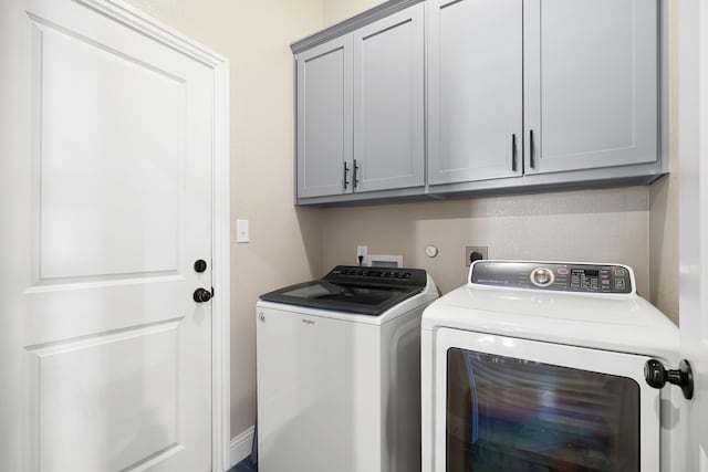 laundry area with cabinets and washer and dryer