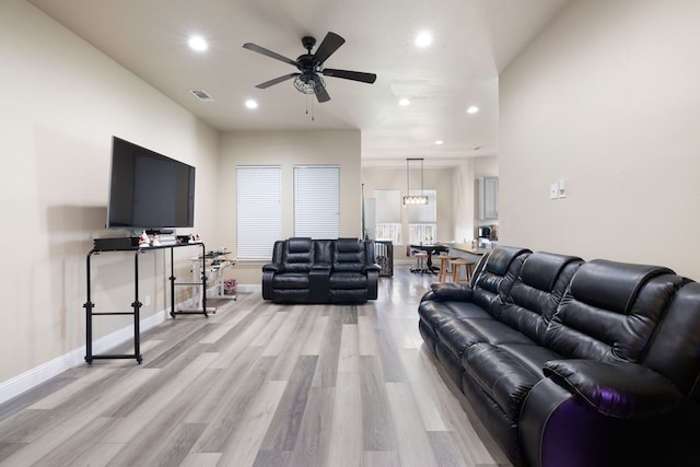 living room with ceiling fan and light wood-type flooring