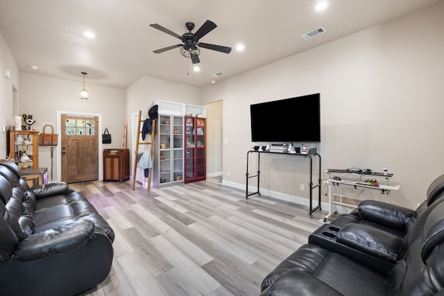 living room featuring light hardwood / wood-style floors and ceiling fan