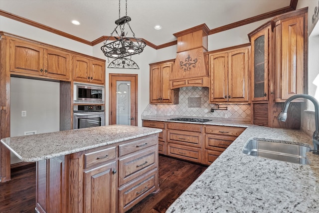 kitchen featuring sink, dark wood-type flooring, stainless steel appliances, light stone counters, and ornamental molding