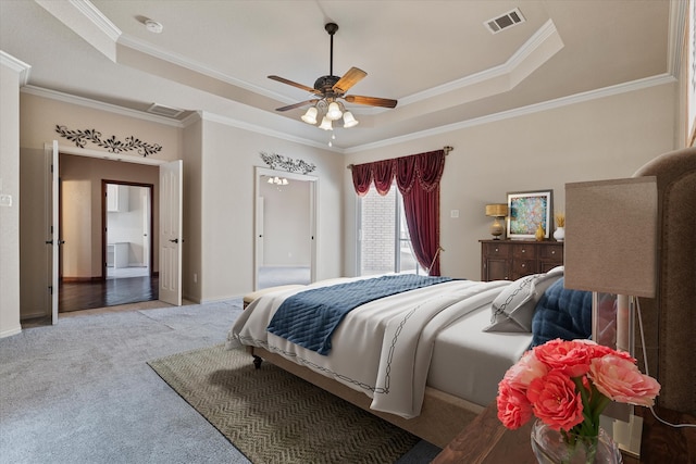 bedroom with ceiling fan, ornamental molding, a raised ceiling, and light carpet