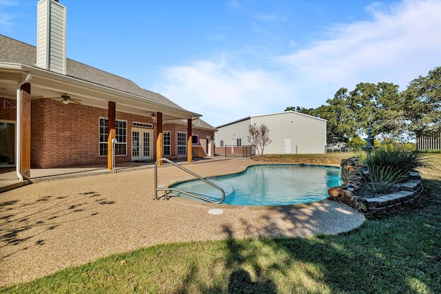 view of swimming pool with ceiling fan, french doors, and a patio