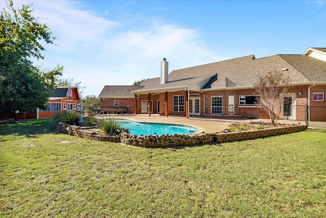 view of swimming pool with a yard and a patio area