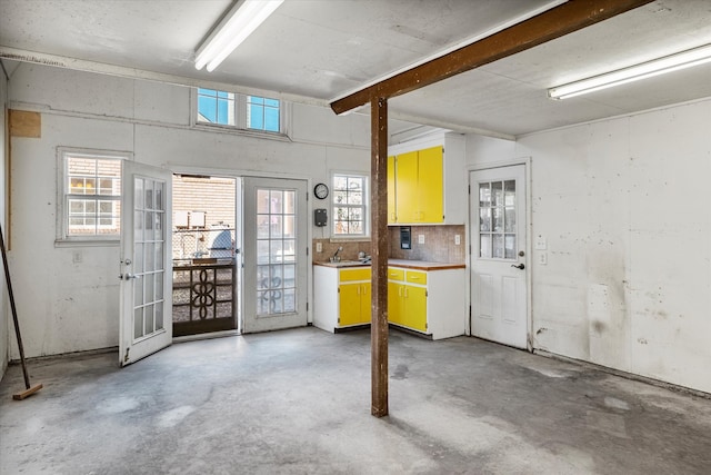 interior space with french doors, a wealth of natural light, and sink