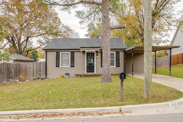 view of front facade with a front lawn and a carport