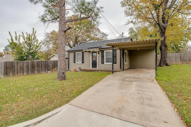 ranch-style house featuring a carport and a front yard