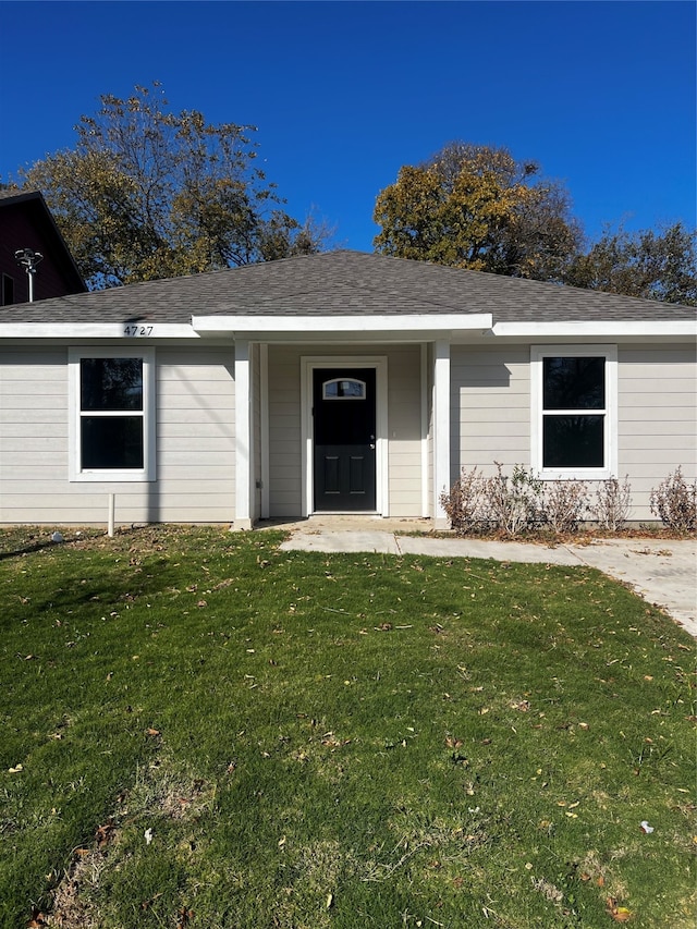 view of exterior entry with a lawn