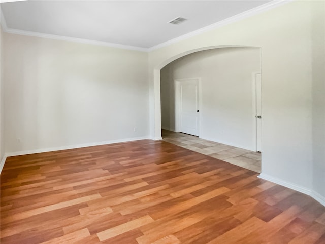 unfurnished room with crown molding and light hardwood / wood-style flooring