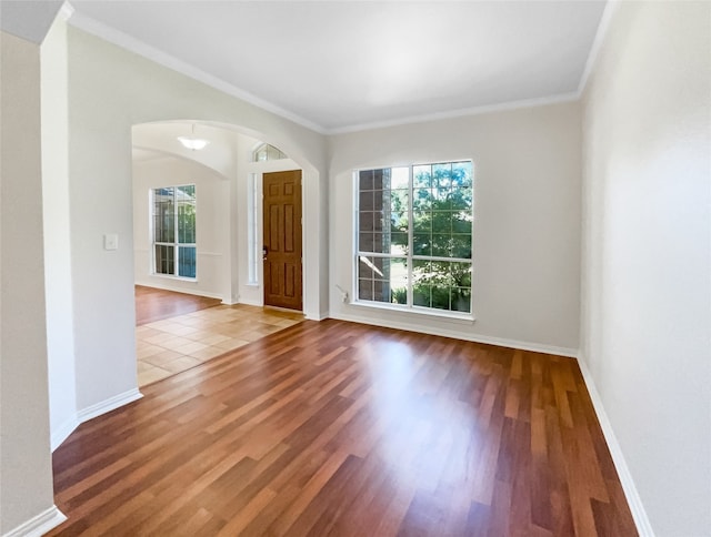 unfurnished room featuring wood-type flooring and ornamental molding