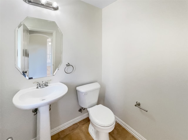 bathroom featuring tile patterned flooring and toilet